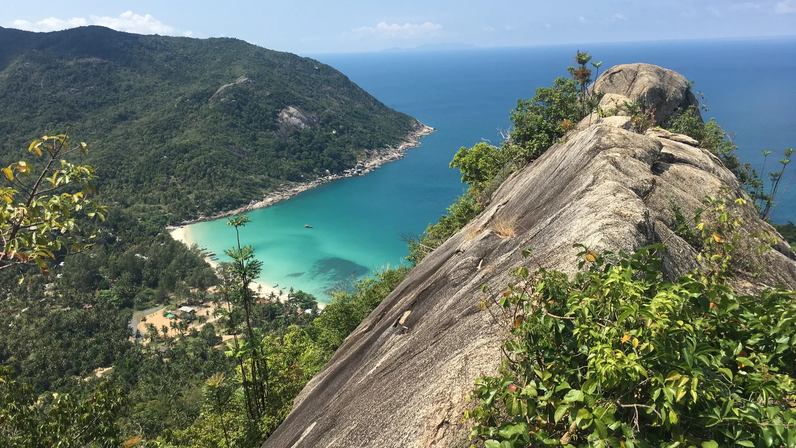 Rocky ridge on the coastal trail above Bottle Beach, with the bay and turquoise water below