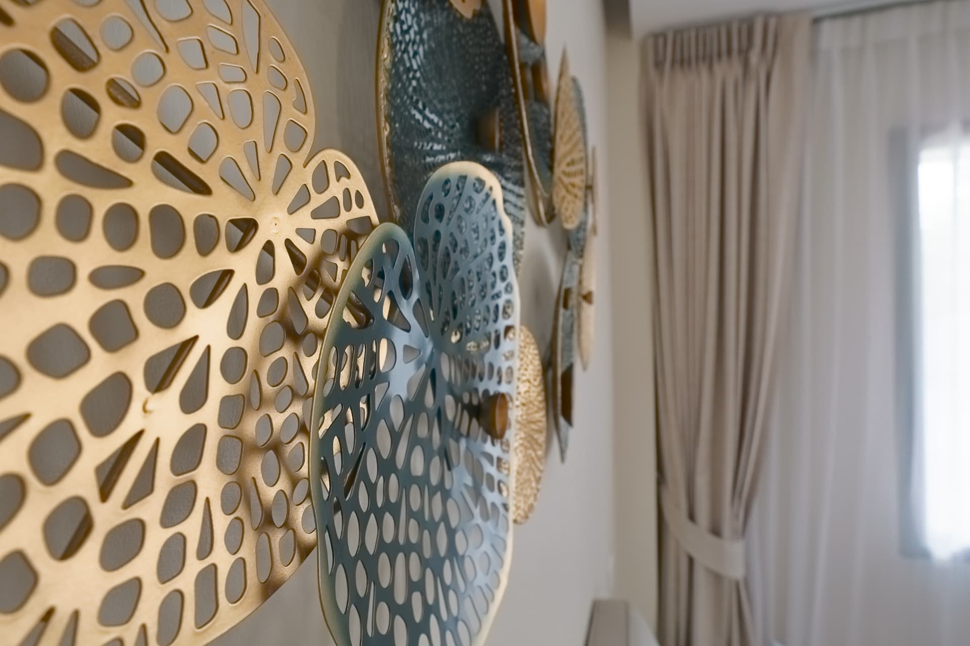 Close-up of the decorative gold and blue wall art in one of the bedrooms